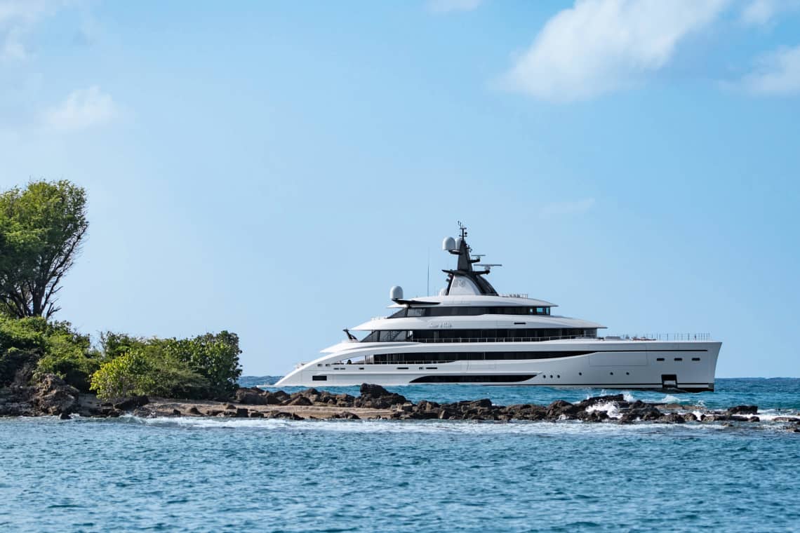Side of Yacht of Blue Waters, Near a Small Patch of Land, against a Blue Sky