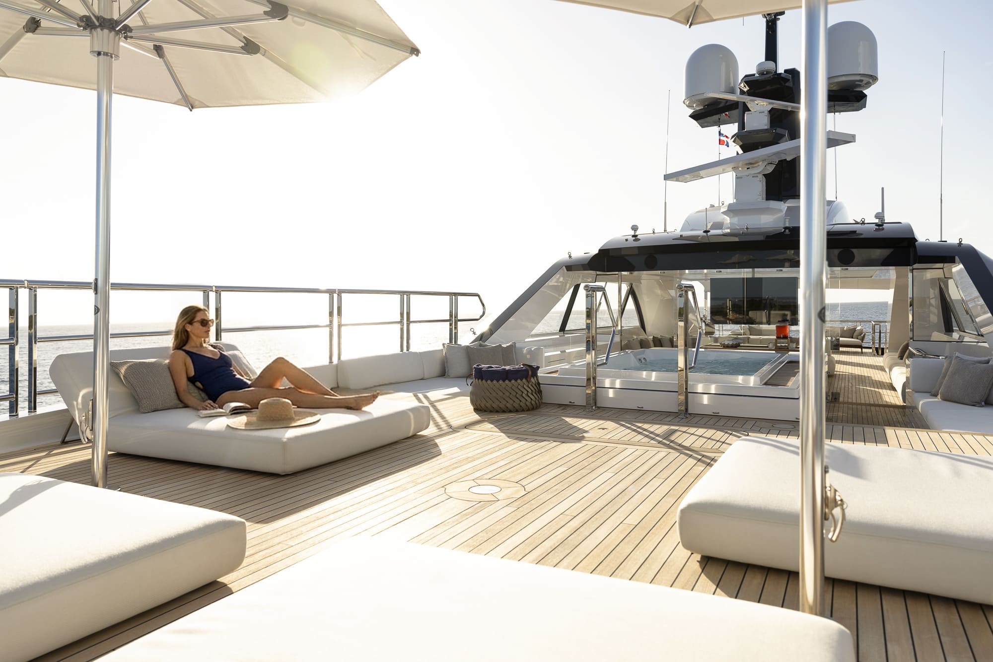 Woman lounging on a couch on the top deck of a yacht