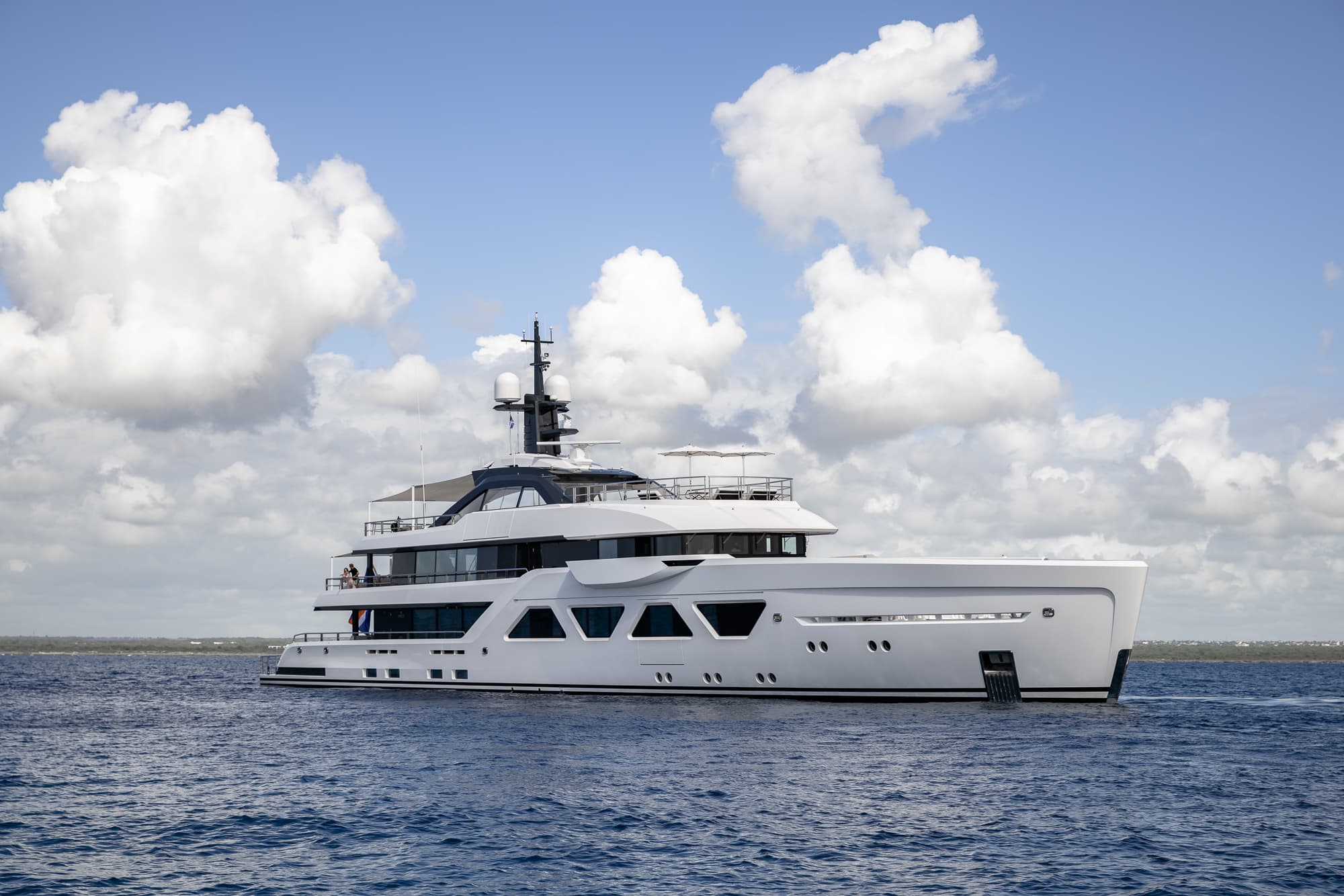 White Superyacht on Blue Waters with a Cloudy Sky