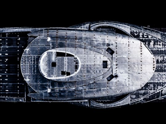 Aerial top down view of a superyacht hull under construction at the shipyard