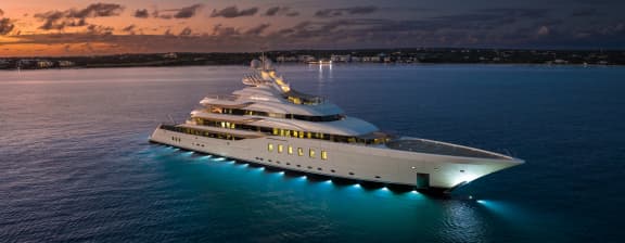 Luxury yacht at night, illuminated on the water