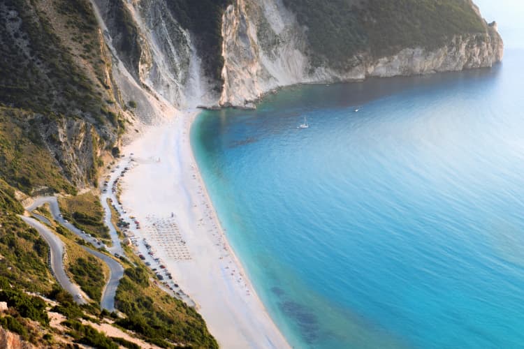 Surrounded by steep limestone cliffs, this iconic beach offers stunning panoramic views of the Ionian Sea.