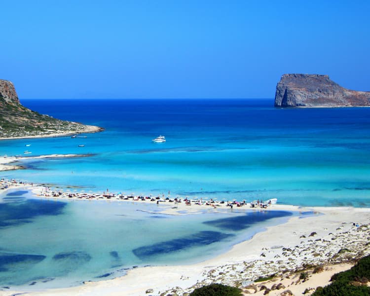 Situated on the northwest coast of Crete, Balos Lagoon is a breathtaking natural wonder with shallow turquoise waters, white sandbars, and pink-hued sand.